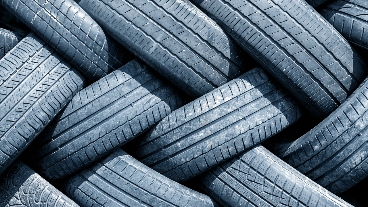 Close-up of stacked worn tire casings and tread — casing prep and buffing is the first step in preparing a used casing for a new tread