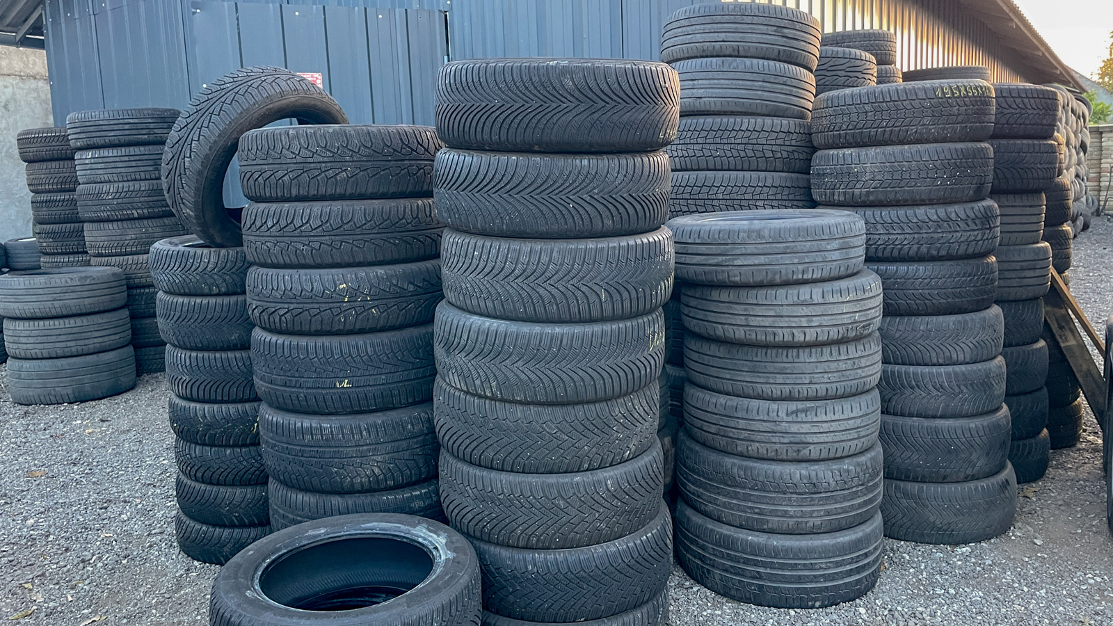 Stack of worn commercial truck tire casings awaiting inspection and grading before retreading