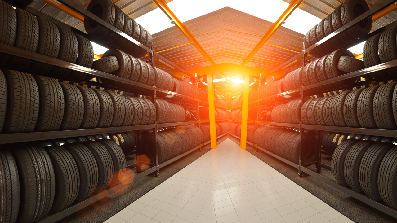 Rows of tire casings stored on warehouse racking — the tracked, retreadable asset behind every retread program