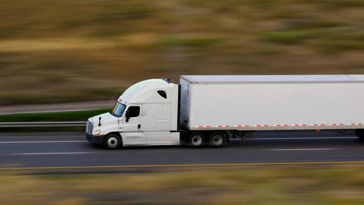 A commercial fleet truck on the highway — fleet operators are the ones driving 2026 retread demand