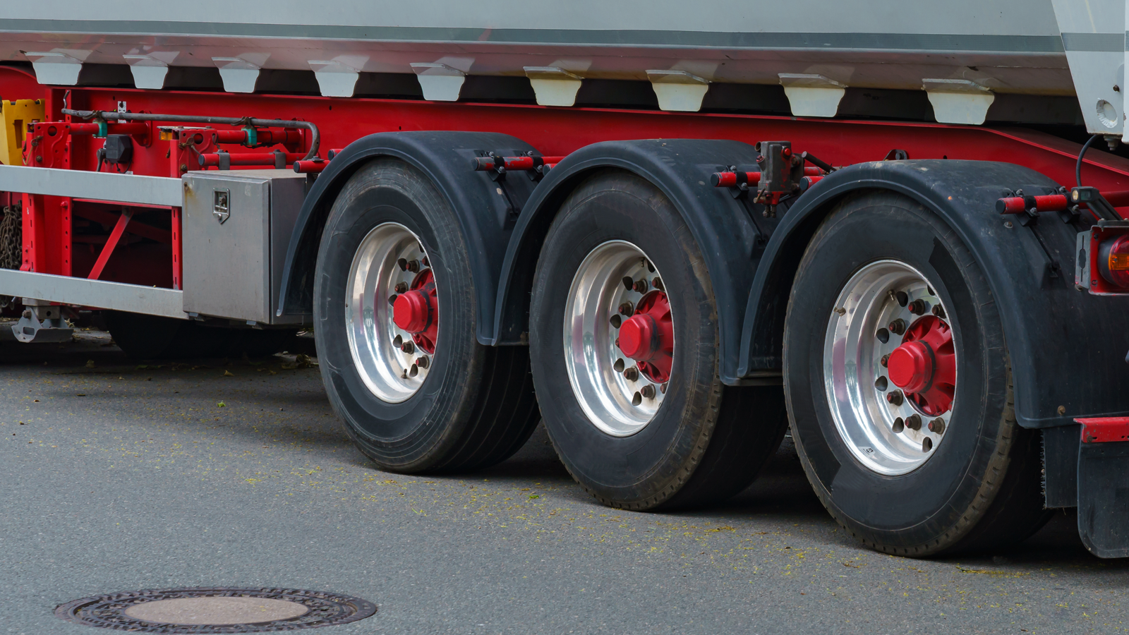 Close-up of the rear tandem tires on a commercial trailer, the kind of casing covered by a retreader's workmanship warranty
