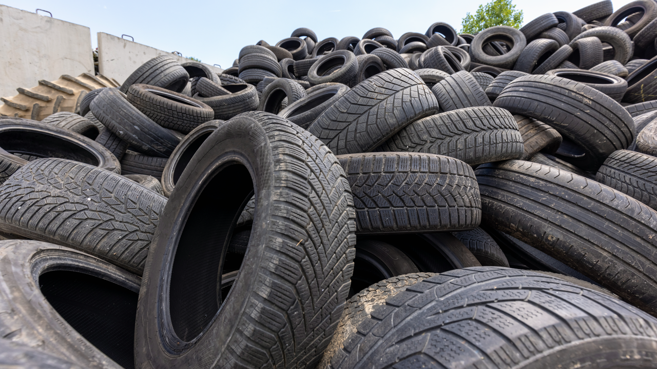 Stacked scrap tires awaiting recycling — end-of-life tire management data